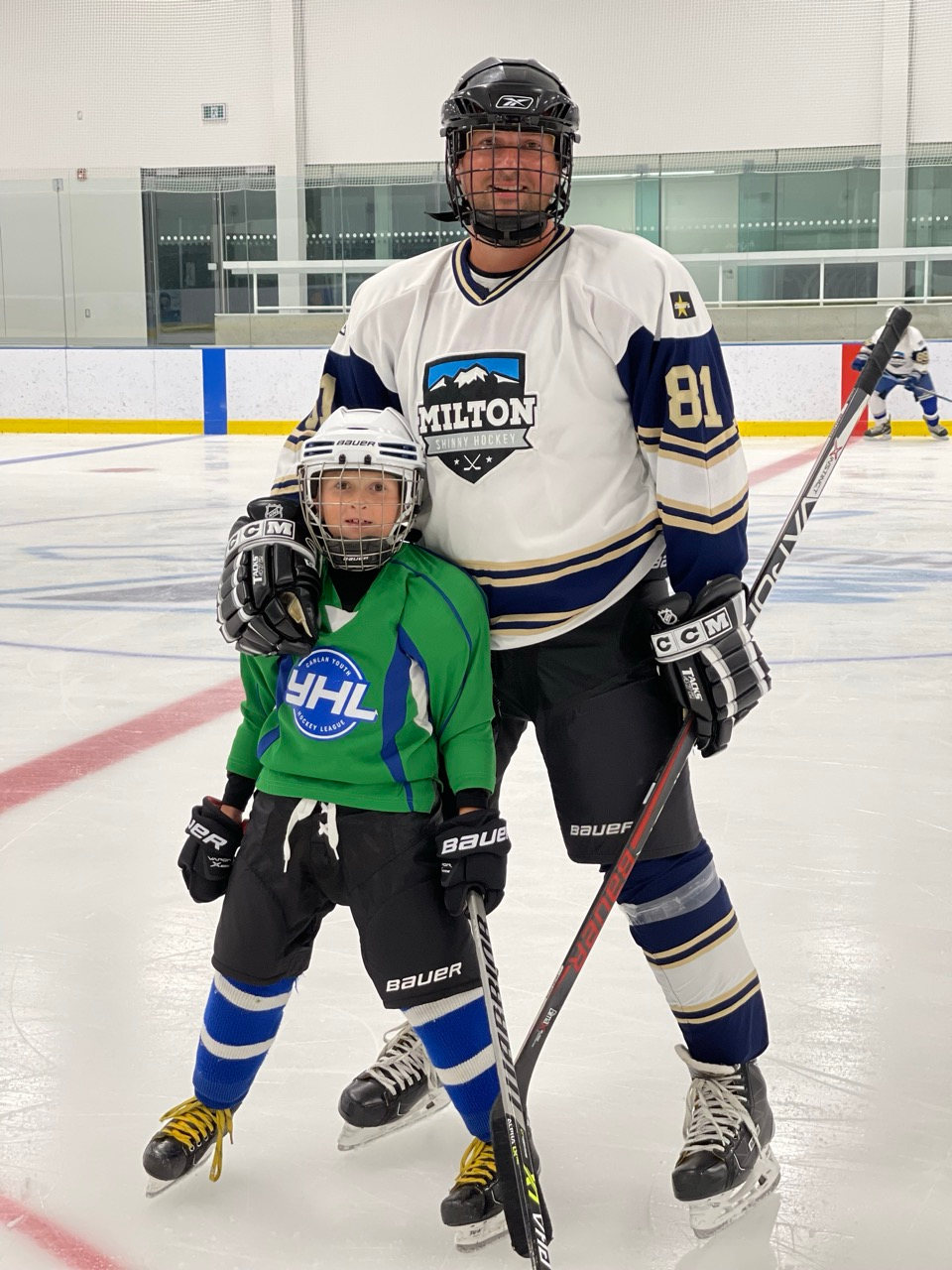 A dad and his young son on the ice