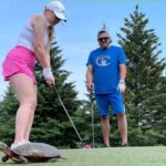 Meagan Hewlett Putting  at MSH Annual Charity Golf Tournament at Turtle Creek Friday June 2nd 2023 with a turtle near the hole.